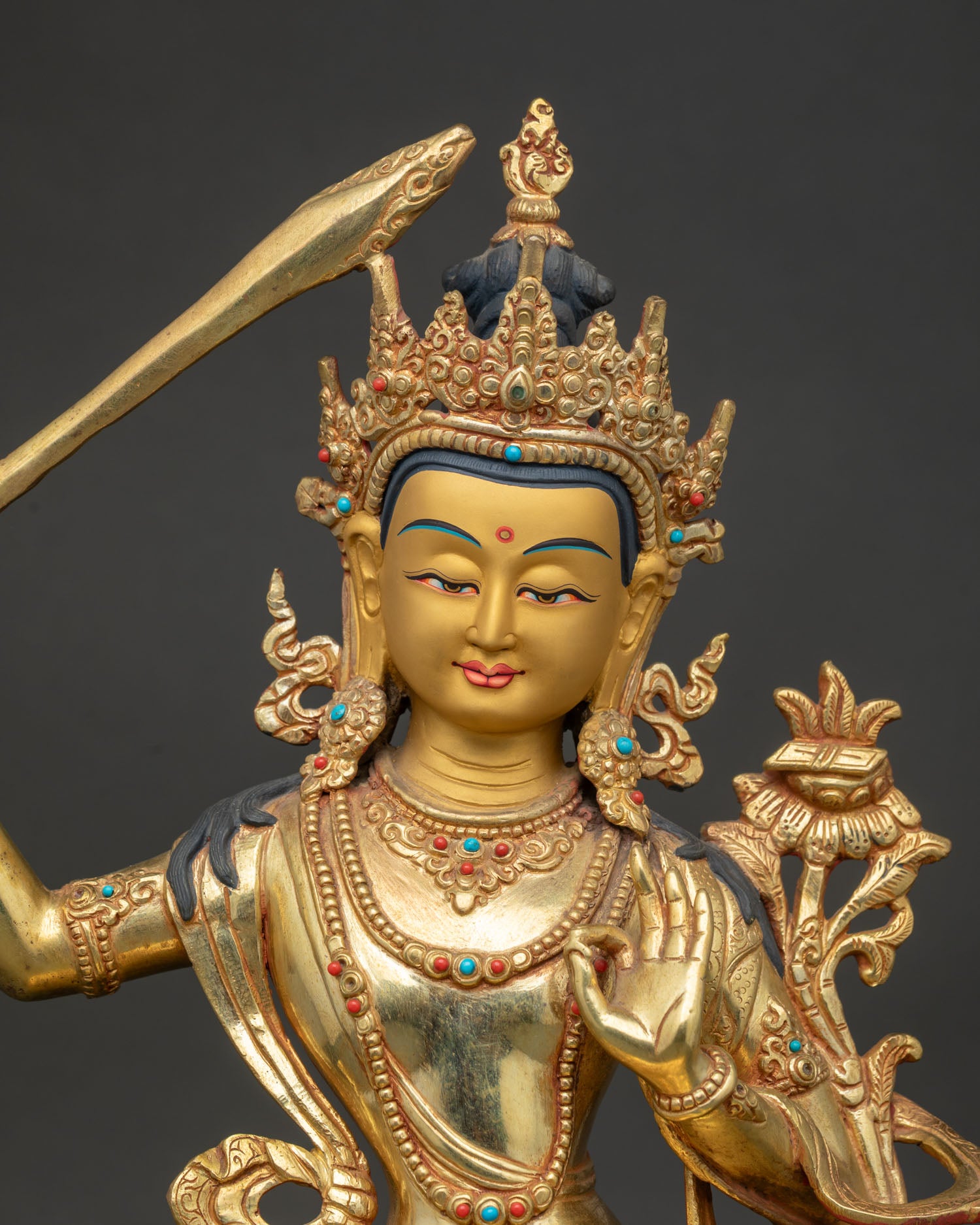 Handcrafted Manjushri Statue with gold painted face and royal garment.