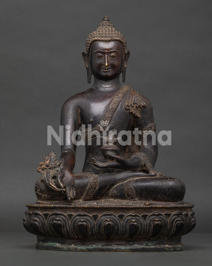 Handcrafted Medicine Buddha statue from Patan Nepal with copper oxidized finish.