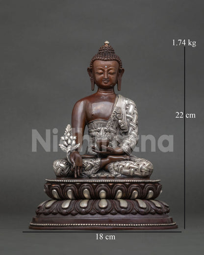 Handcrafted medicine buddha statue from patan nepal with oxidized copper and silver plated details.