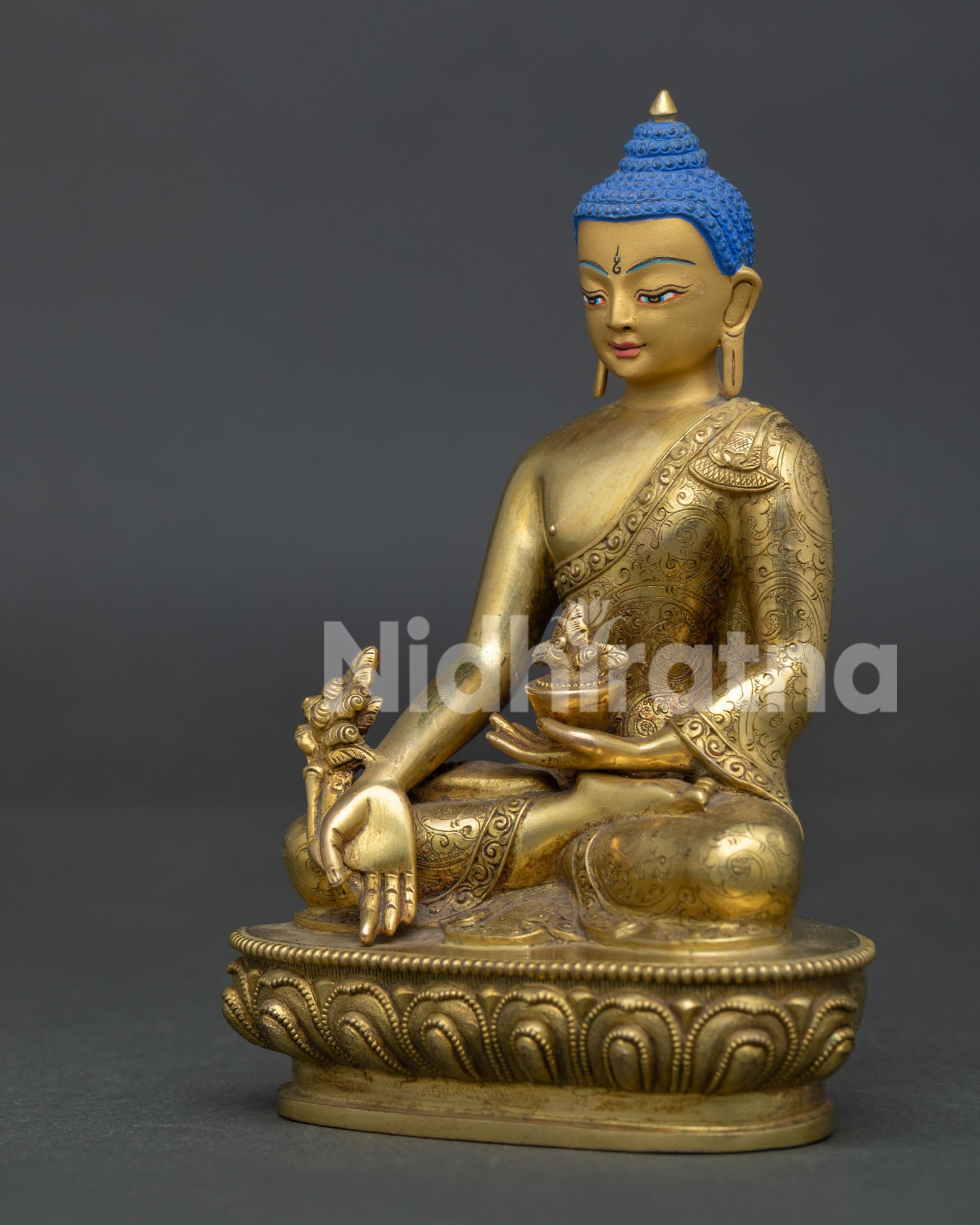 Handcrafted medicine buddha statue with gold gilded copper body from patan nepal.