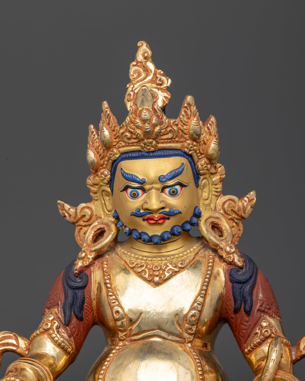 Handcrafted Nepalese Dzambhala wealth deity statue with gold painted face