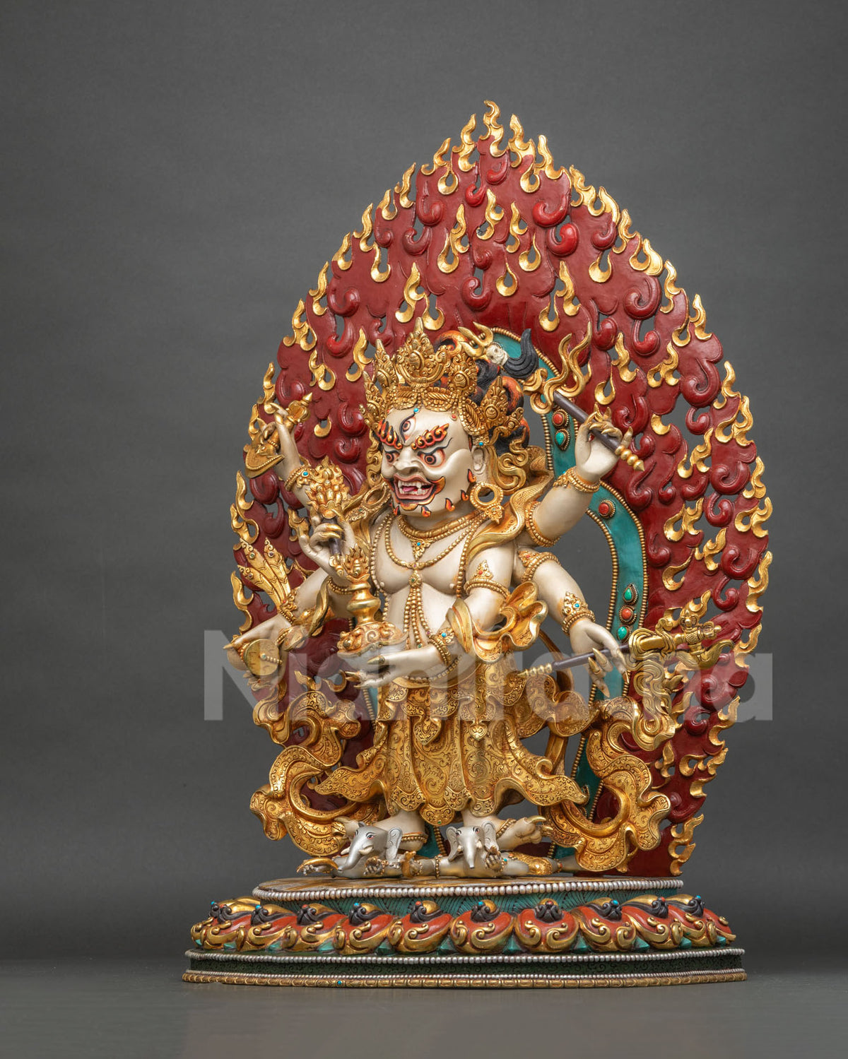 Handcrafted Nepalese White Mahakala statue with luminous white body and crimson and gold flame halo