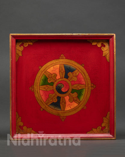 Handcrafted Nepalese wooden tray from Patan with Dharma Chakra Buddhist symbol.