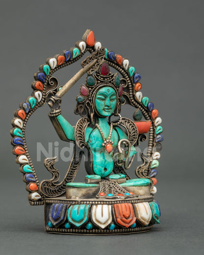 Handcrafted Newari Manjushri statue in turquoise with gemstone crown and coral utpala flower