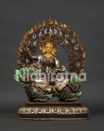 Handcrafted oxidized copper Tsheringma statue on snow lion, front view.