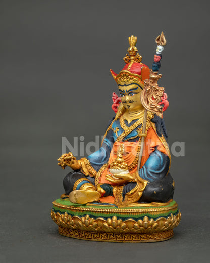 Handcrafted Padmasambhava statue holding the Vajra scepter and Khatvanga trident staff.