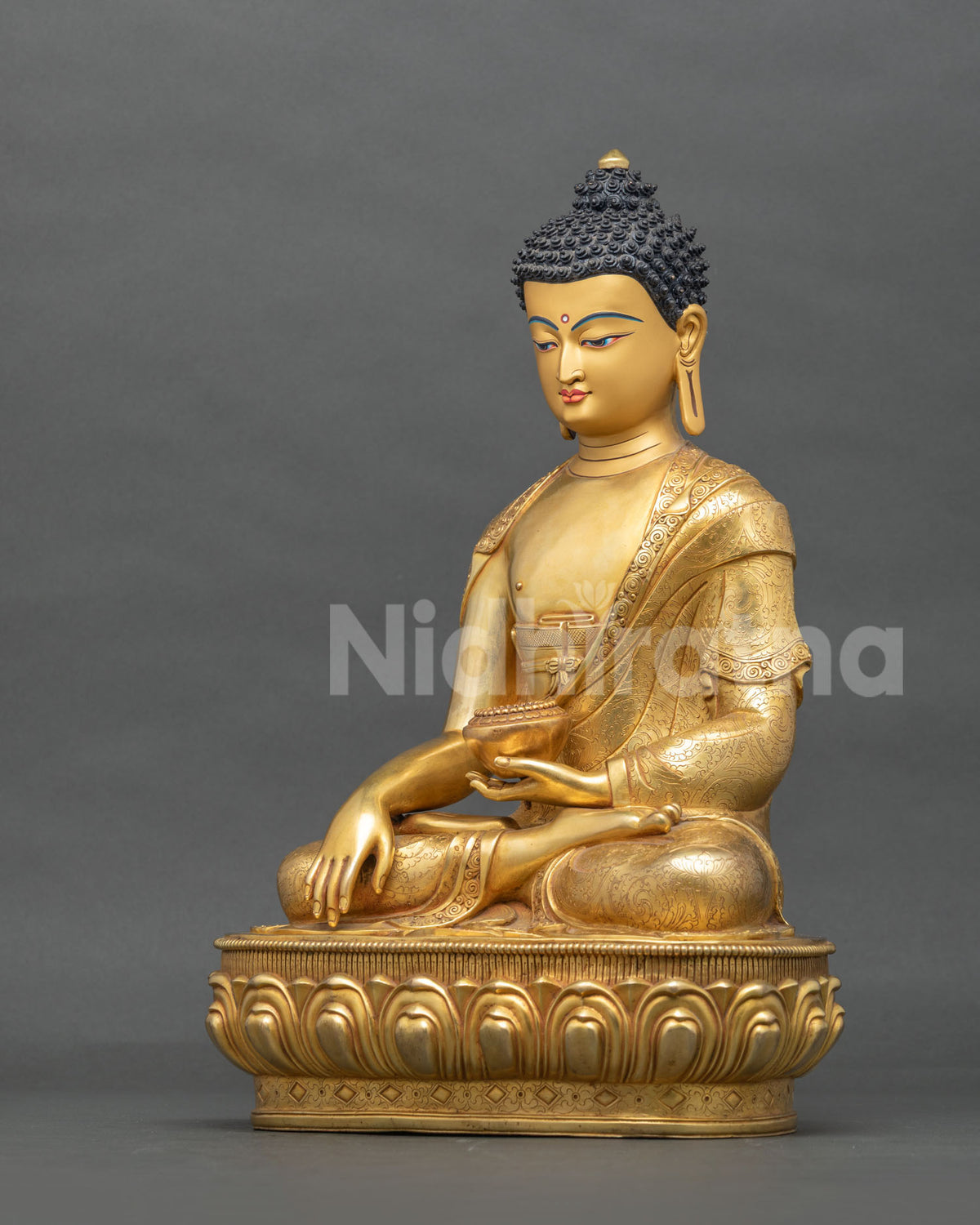 Handcrafted Shakyamuni Buddha statue angled view with lotus pedestal and hand-chased gold robe