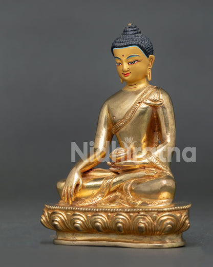 Handcrafted Shakyamuni Buddha statue in gold gilded copper with lotus pedestal from Nepal.