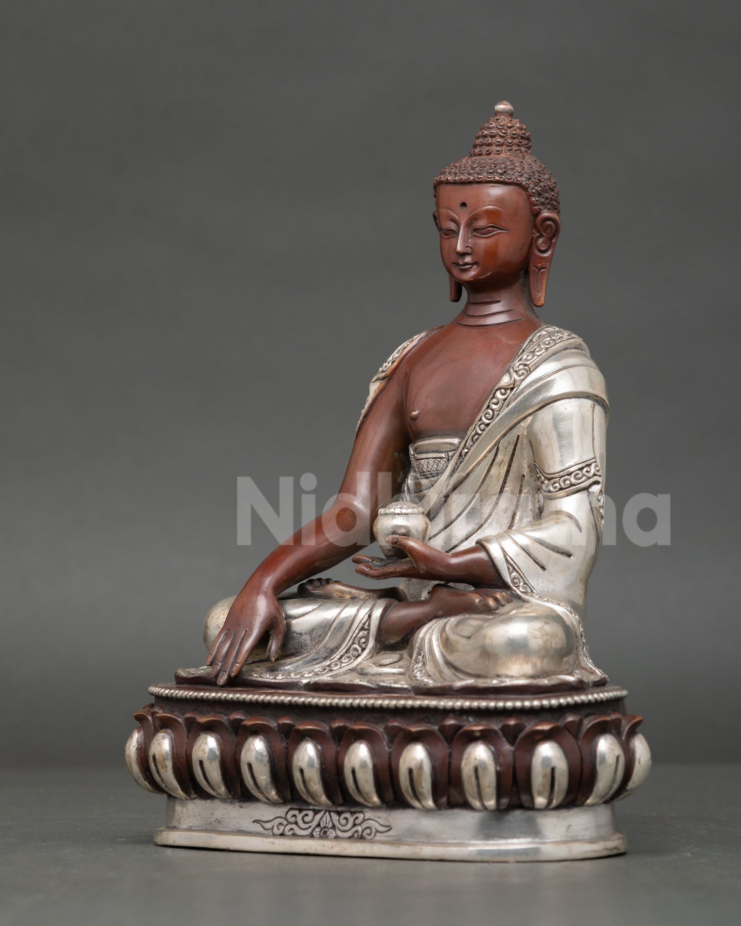 Handcrafted shakyamuni buddha statue with silver plated copper finish from patan nepal.