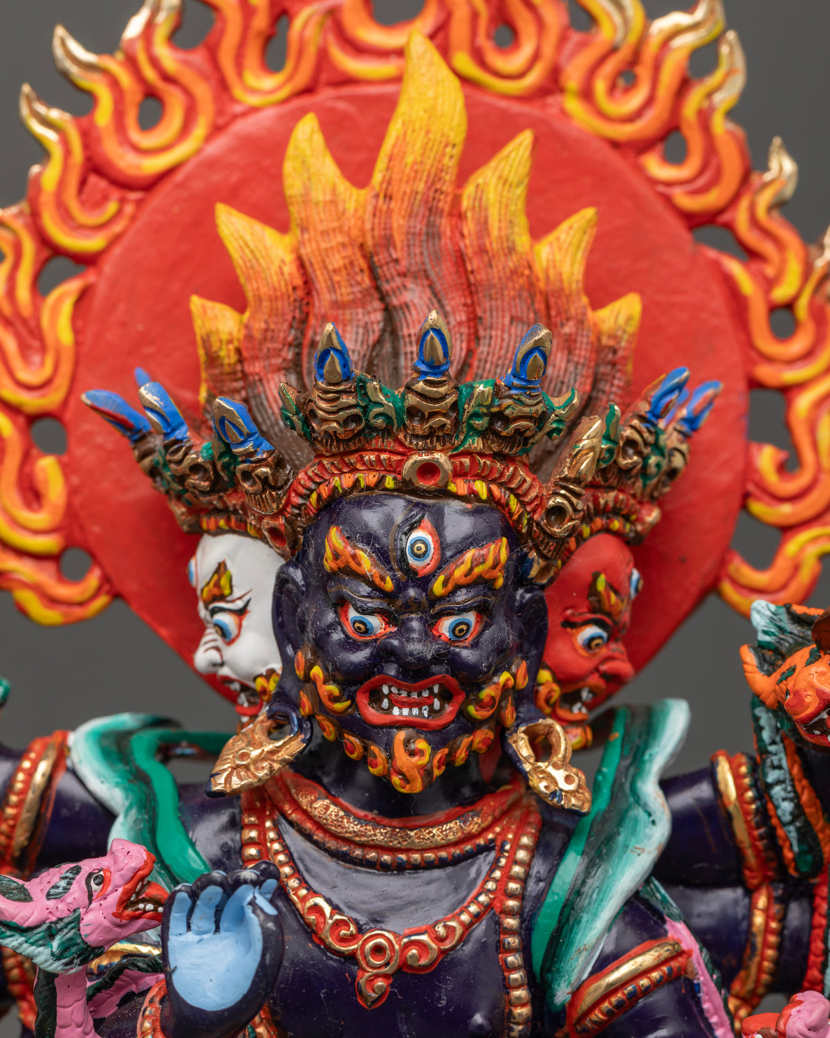 Handcrafted Ucchusma statue with three wrathful faces and multiple arms.