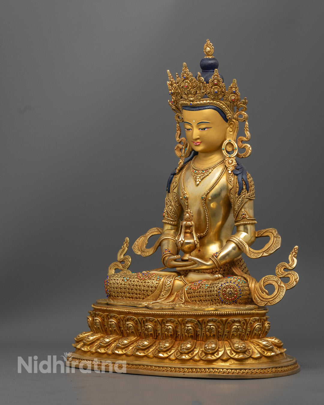 handcrafted Amitayus Buddha statue in gold-gilded copper, seated in lotus posture holding a longevity vase, symbolizing infinite life.
