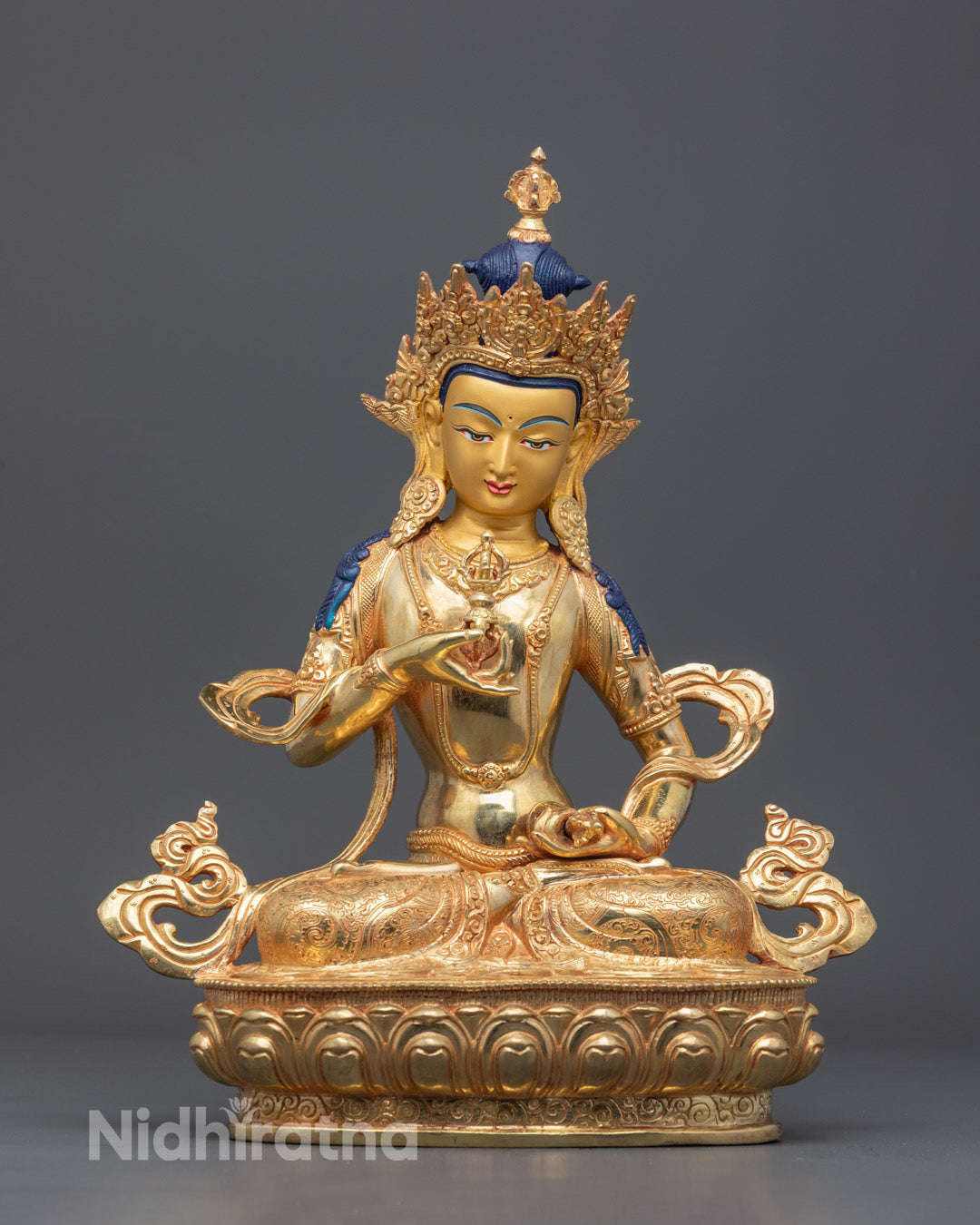 handcrafted Vajrasattva statue with gold-gilded face and fire-gilded body, seated on a lotus throne, symbolizing purification and spiritual renewal.