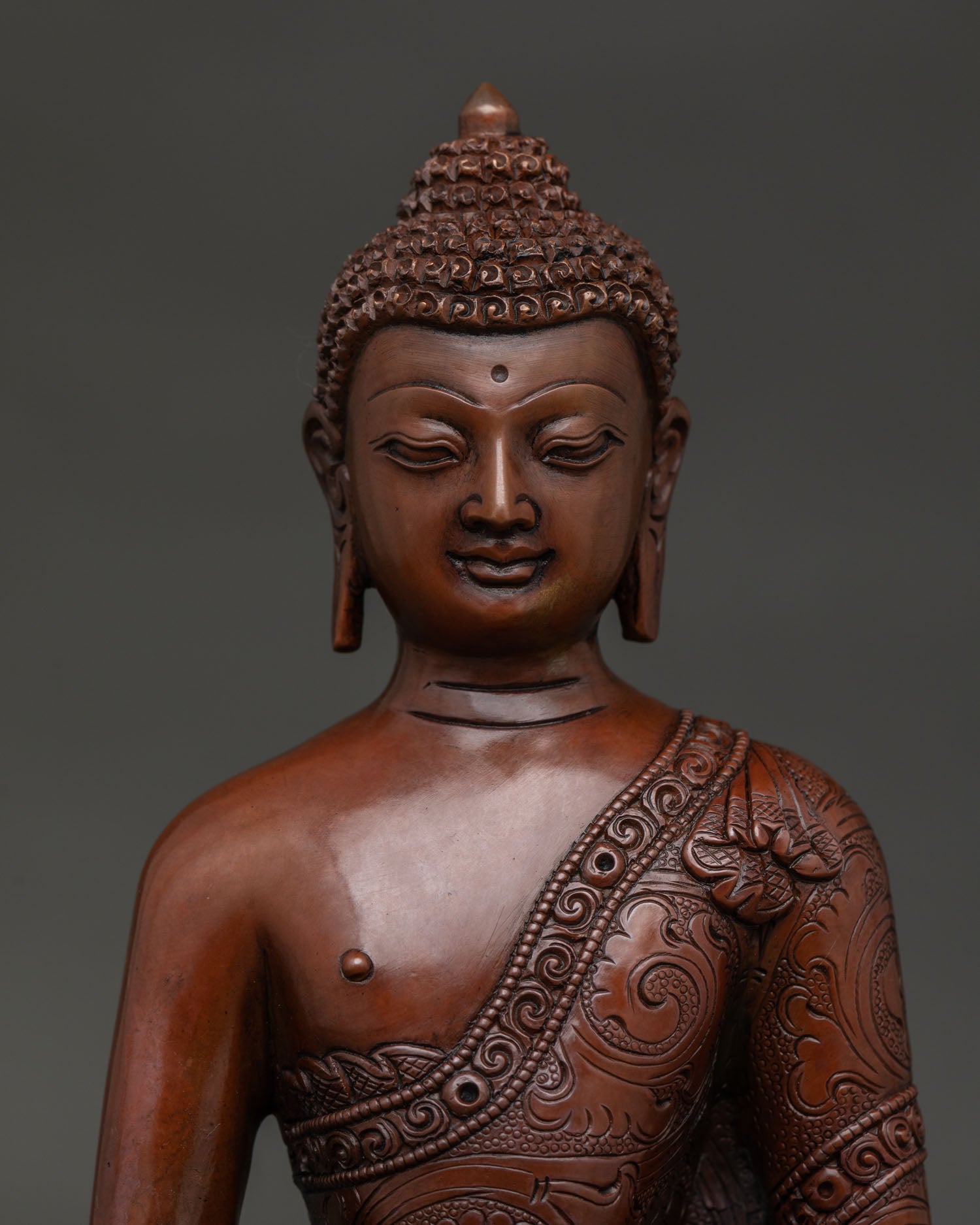 Handmade Amitabha Buddha statue from Nepal with floral motif robe close up.
