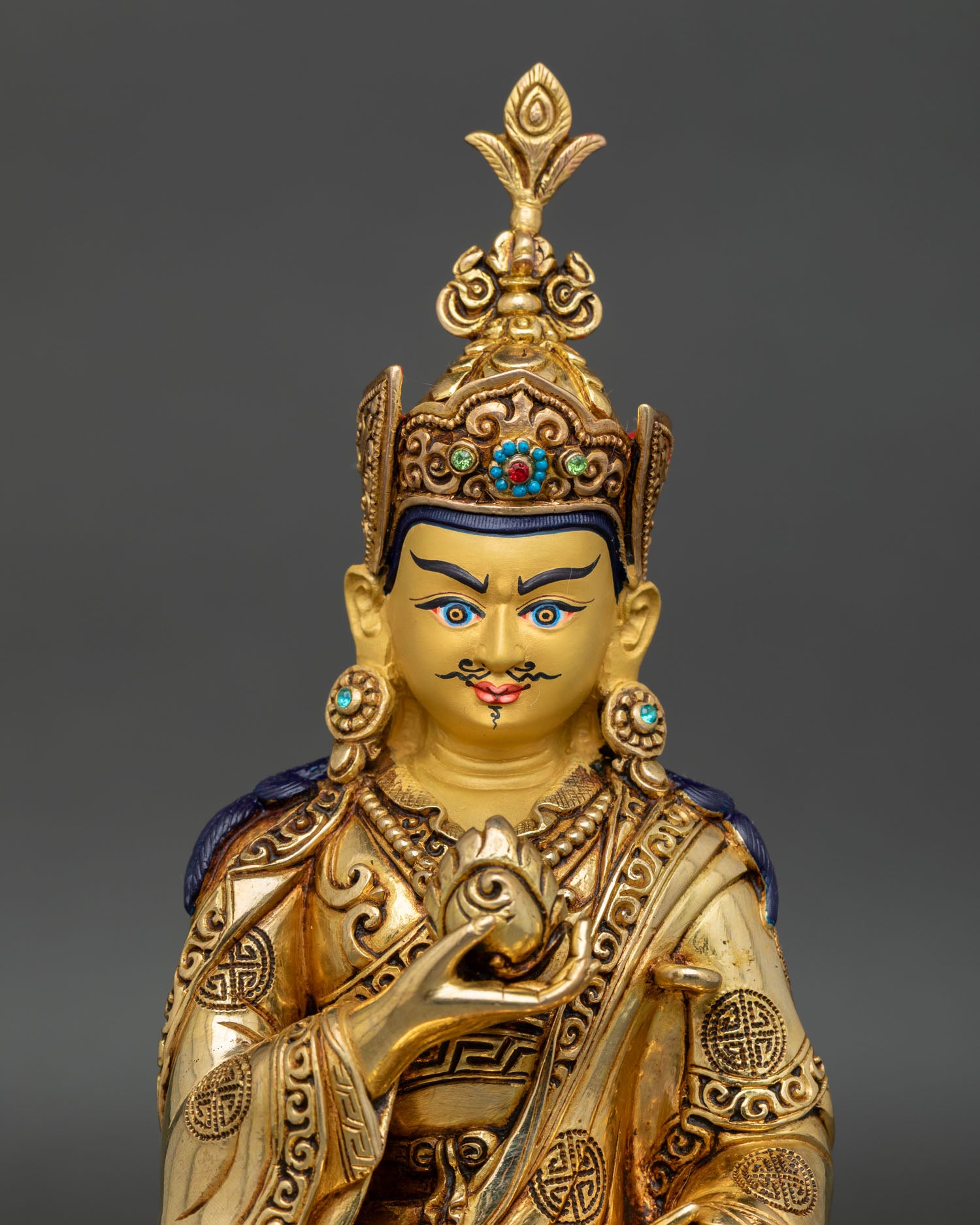 Handmade copper Guru Norla statue from Patan, Nepal, showing lotus hat vulture feather and sacred symbolic objects