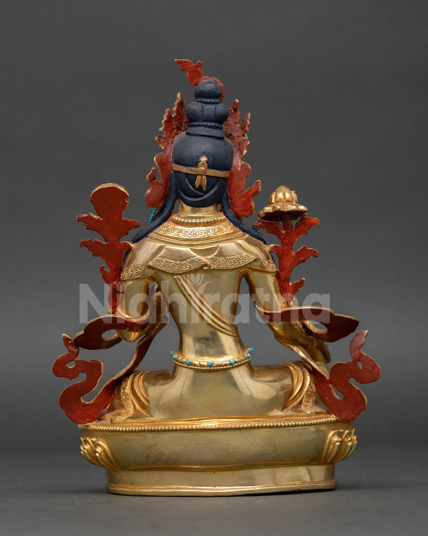 Handmade Green Tara statue from Nepal featuring lotus flower seat, compassionate deity symbolism, and spiritual altar artwork.