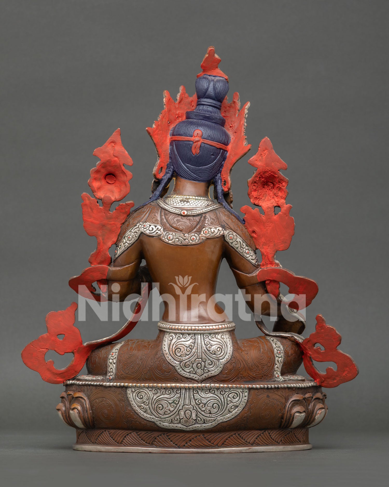 Handmade Green Tara statue from Nepal featuring lotus flower seat, extended leg posture, and sacred Buddhist meditation design.