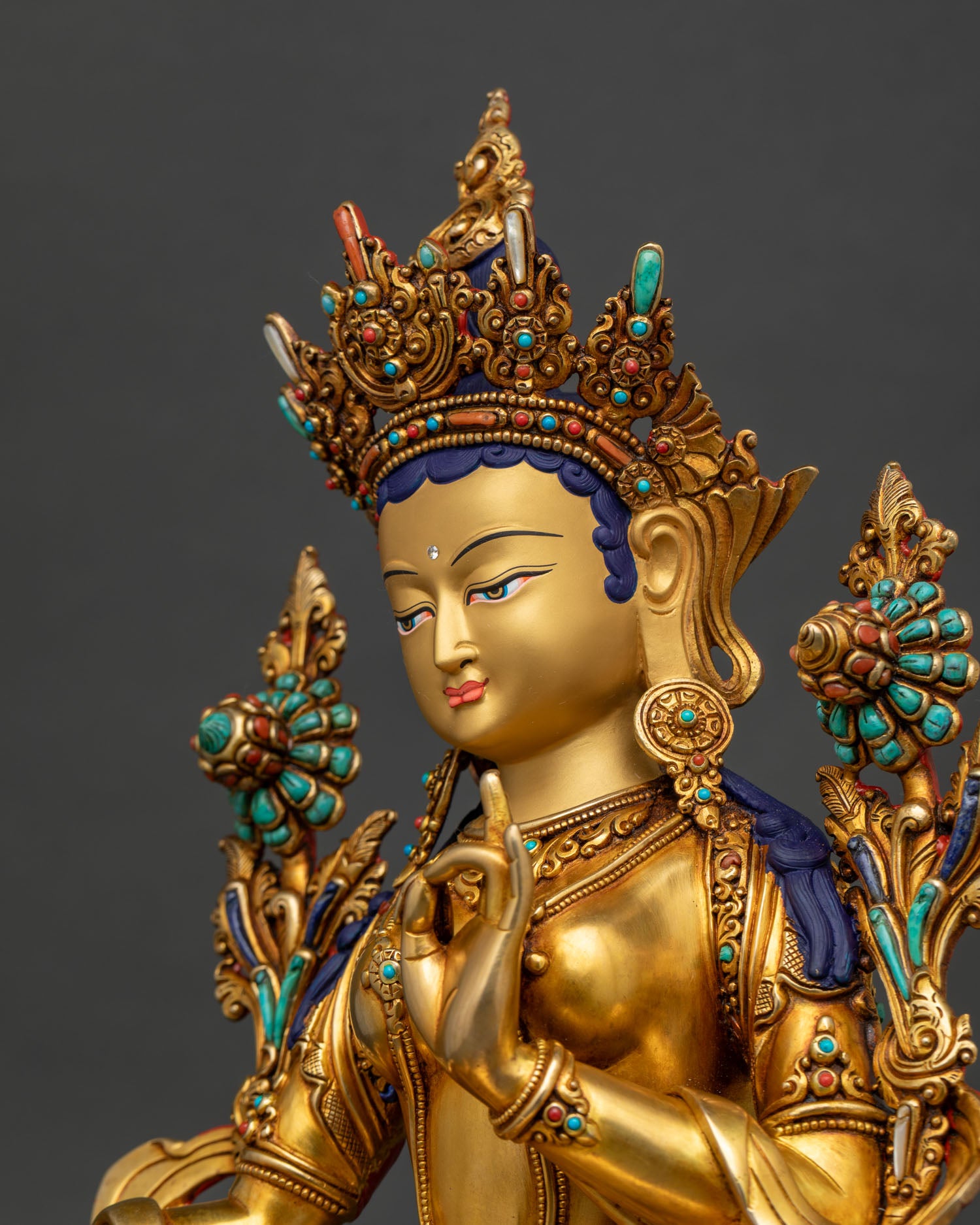Handmade Green Tara statue with turquoise and coral inlays, detailed side close-up view