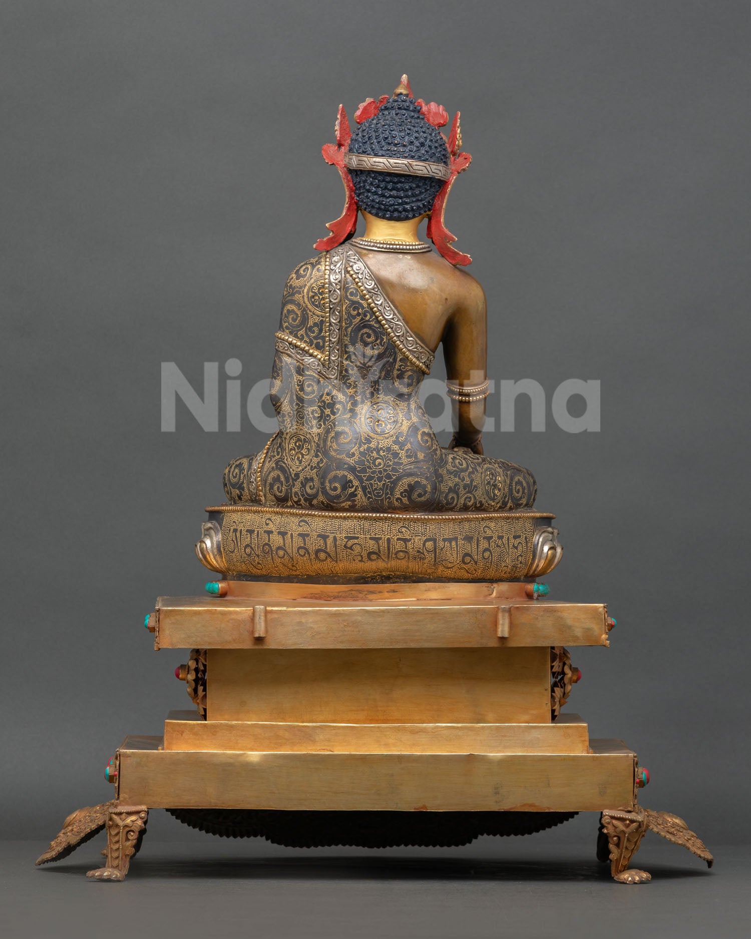 Handmade Nepalese Buddha statue with silver plated details and intricate traditional artistry