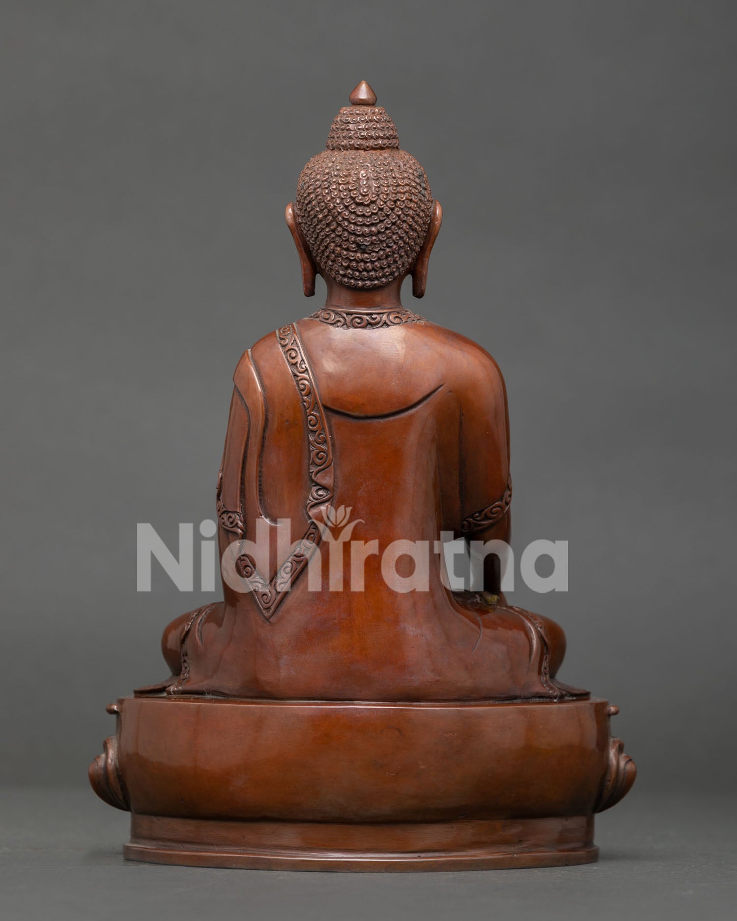 Handmade Shakyamuni Buddha statue featuring oxidized copper texture, detailed robe carving, and sacred Buddhist design.