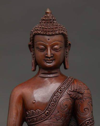 Handmade Shakyamuni Buddha statue from Nepal with floral robe. close up