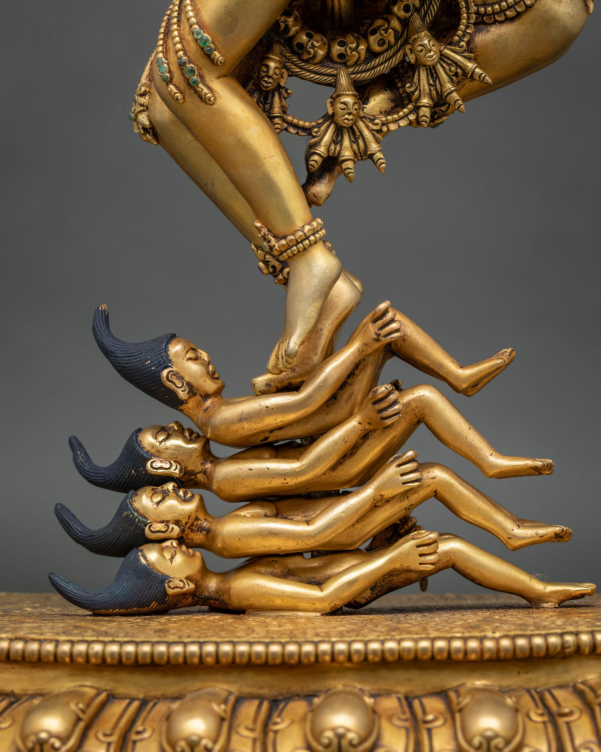 Hevajra’s foot crushing four Maras on lotus base, hand-carved gold fire-gilded copper detail