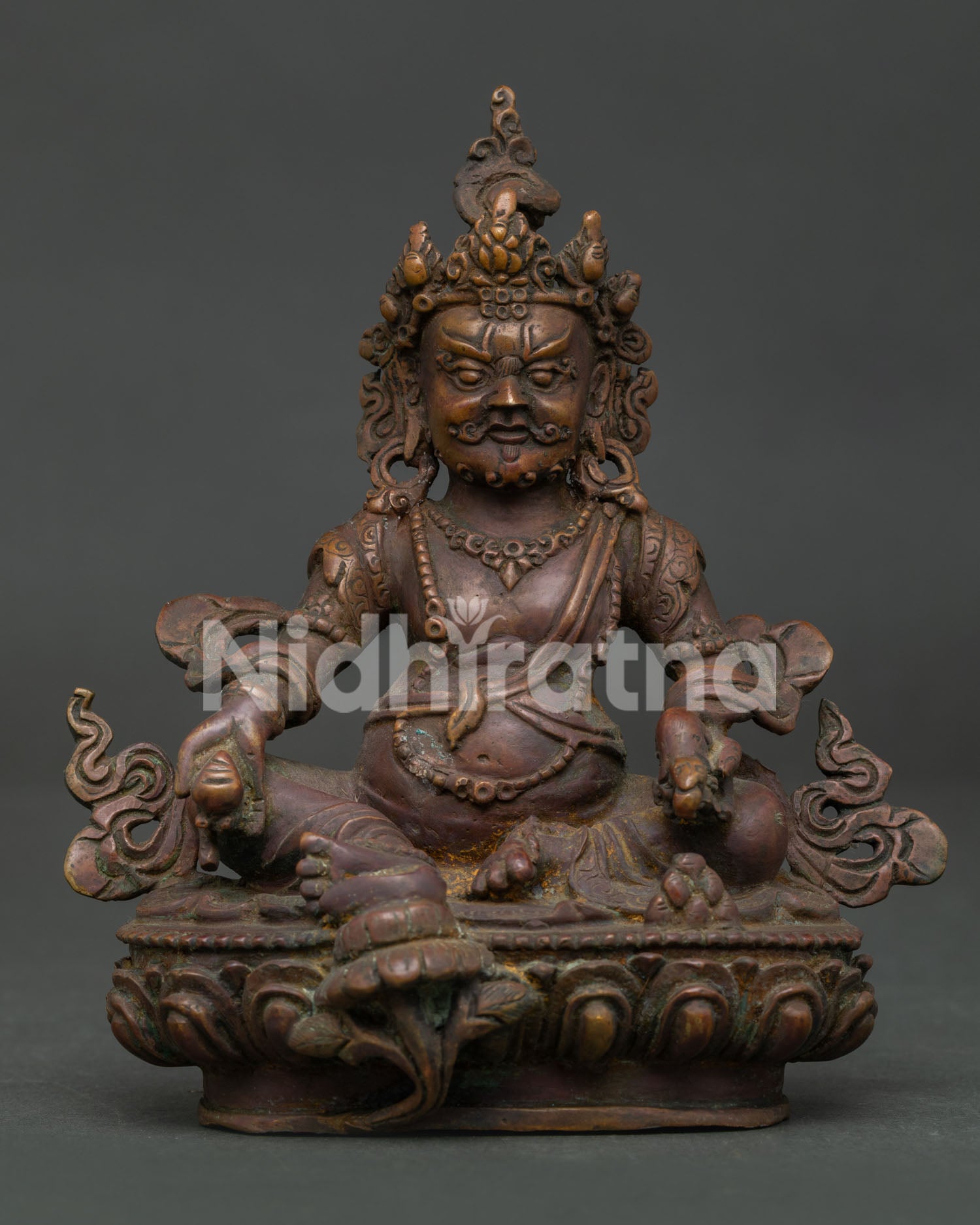 Himalayan Dzambhala statue with lotus base mongoose and citron fruit symbols.