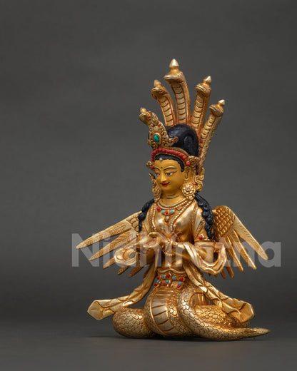 Himalayan Naga Kanya deity statue with coiled serpent form and delicate wings.