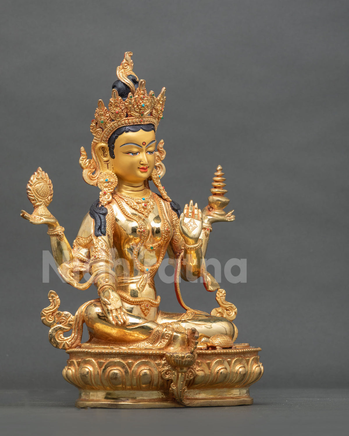 Hindu Goddess Laxmi statue holding a golden mirror and sacred vase with Varada and Abhaya Mudras