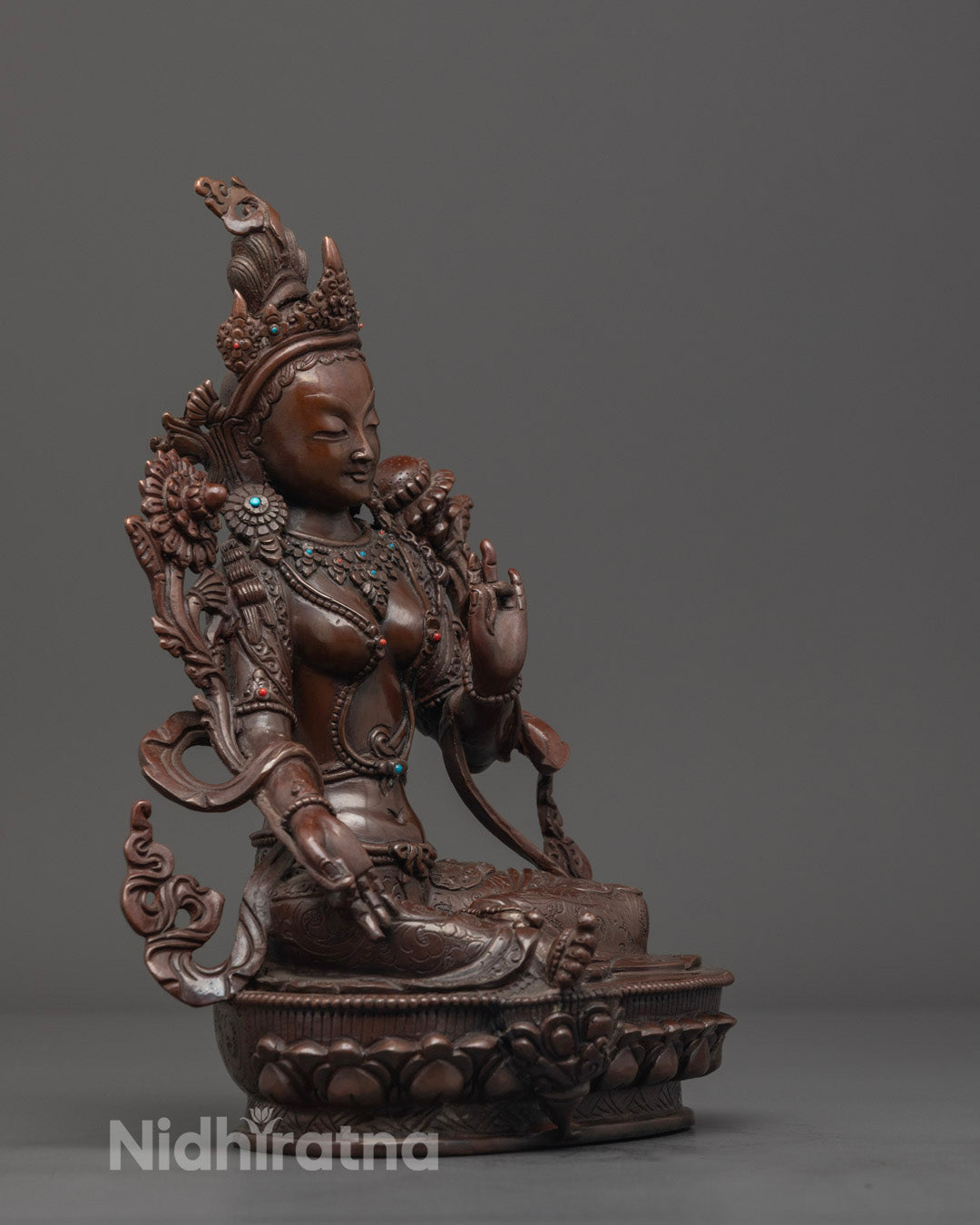 precise carvings on the lotus throne and upala flowers of the oxidized copper statue