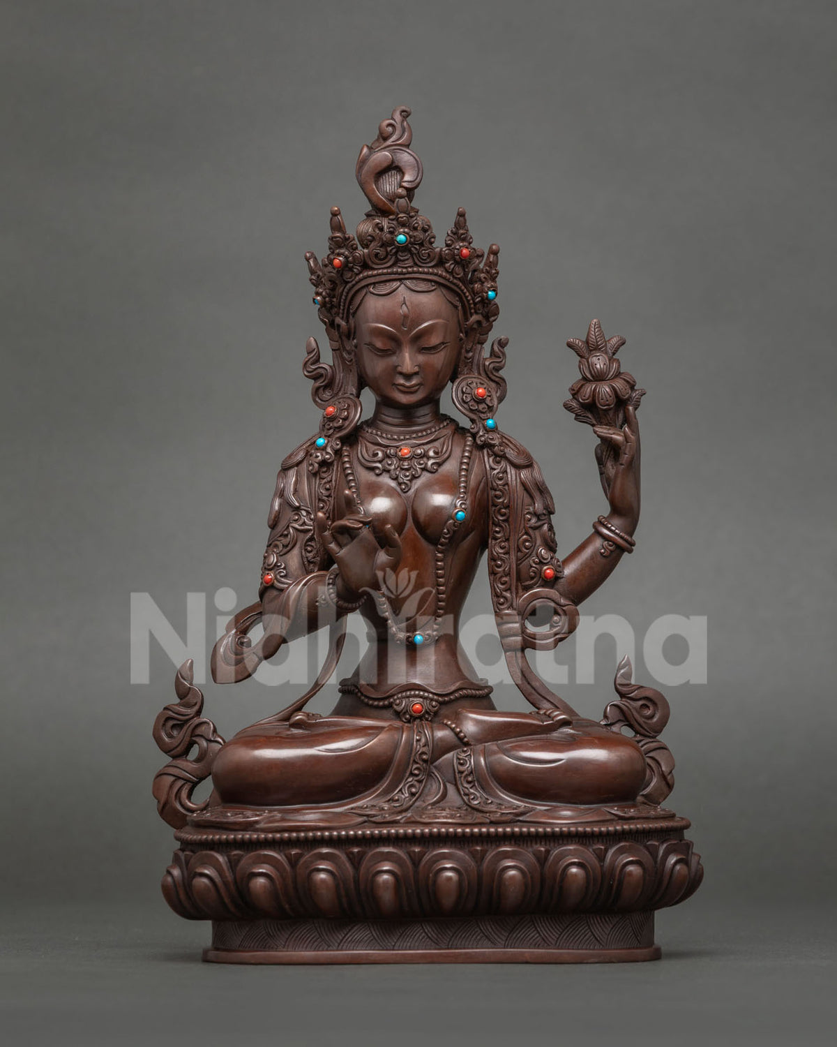 Humsvara-nadini Tara statue holding an utpala, resounding with HUM, oxidized copper
