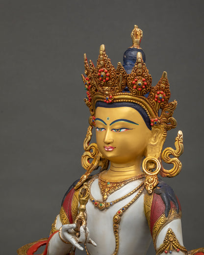Side close-up of Vajrasattva statue showing crown detail and lotus pedestal