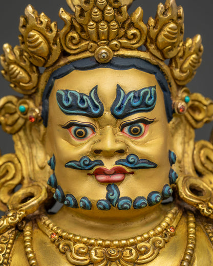 Jambhala Buddha face detail, handcrafted Wealth God with gold fire-gilding and turquoise markings