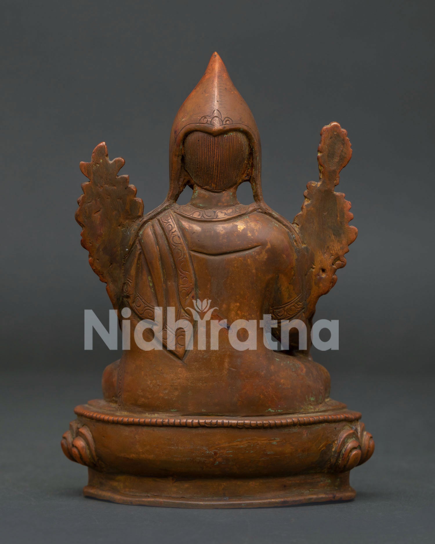 Je Tsongkhapa statue back view highlighting handcrafted copper artistry and Himalayan metalwork.