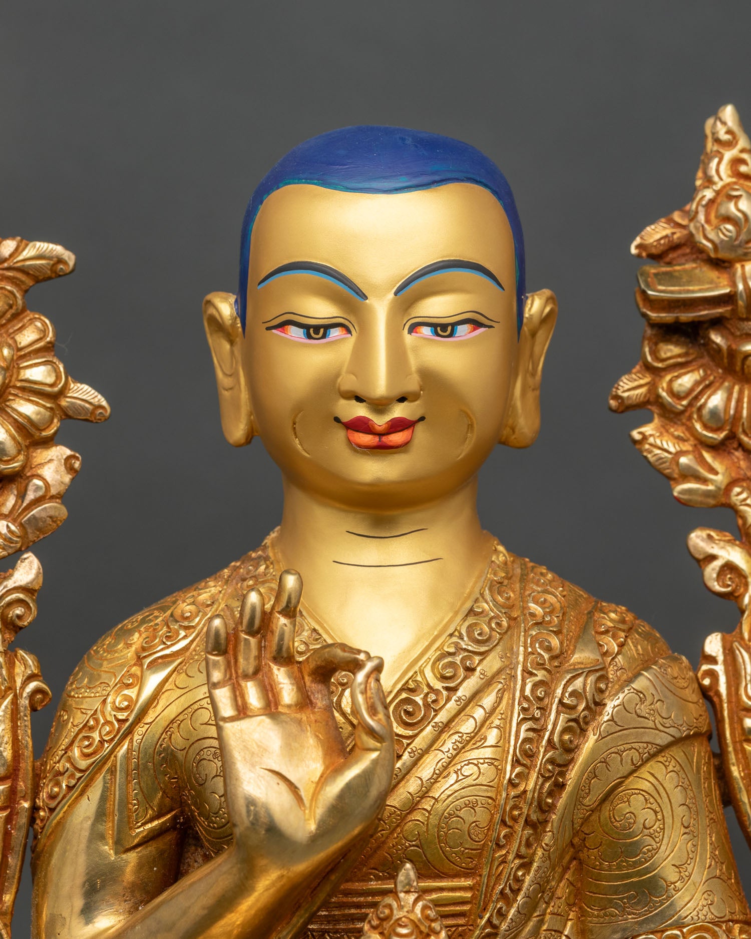 Close-up of Je Tsongkhapa statue showing gold gilding and lotus pedestal details