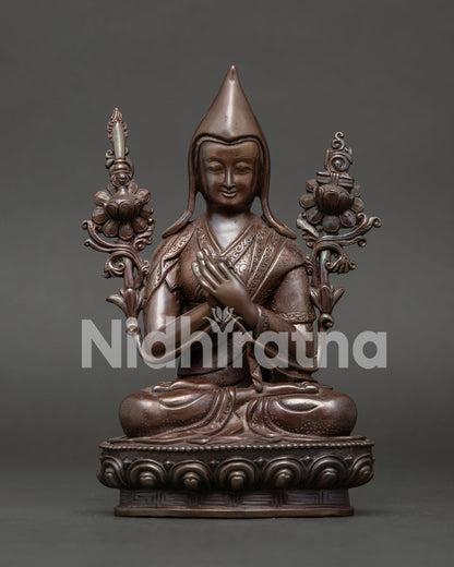 Je Tsongkhapa statue front view oxidized copper founder of the Gelug Tradition on lotus pedestal.