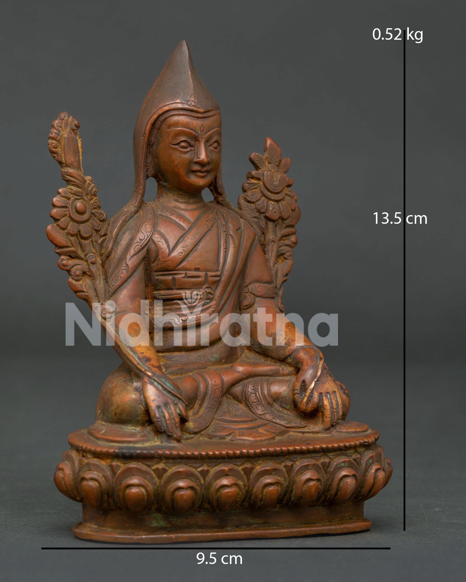 Je Tsongkhapa statue side view displaying lotus stems vajra posture and traditional Buddhist details.