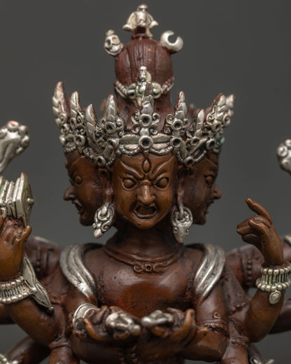 Kalachakra statue showing sacred ritual implements and oxidized copper.