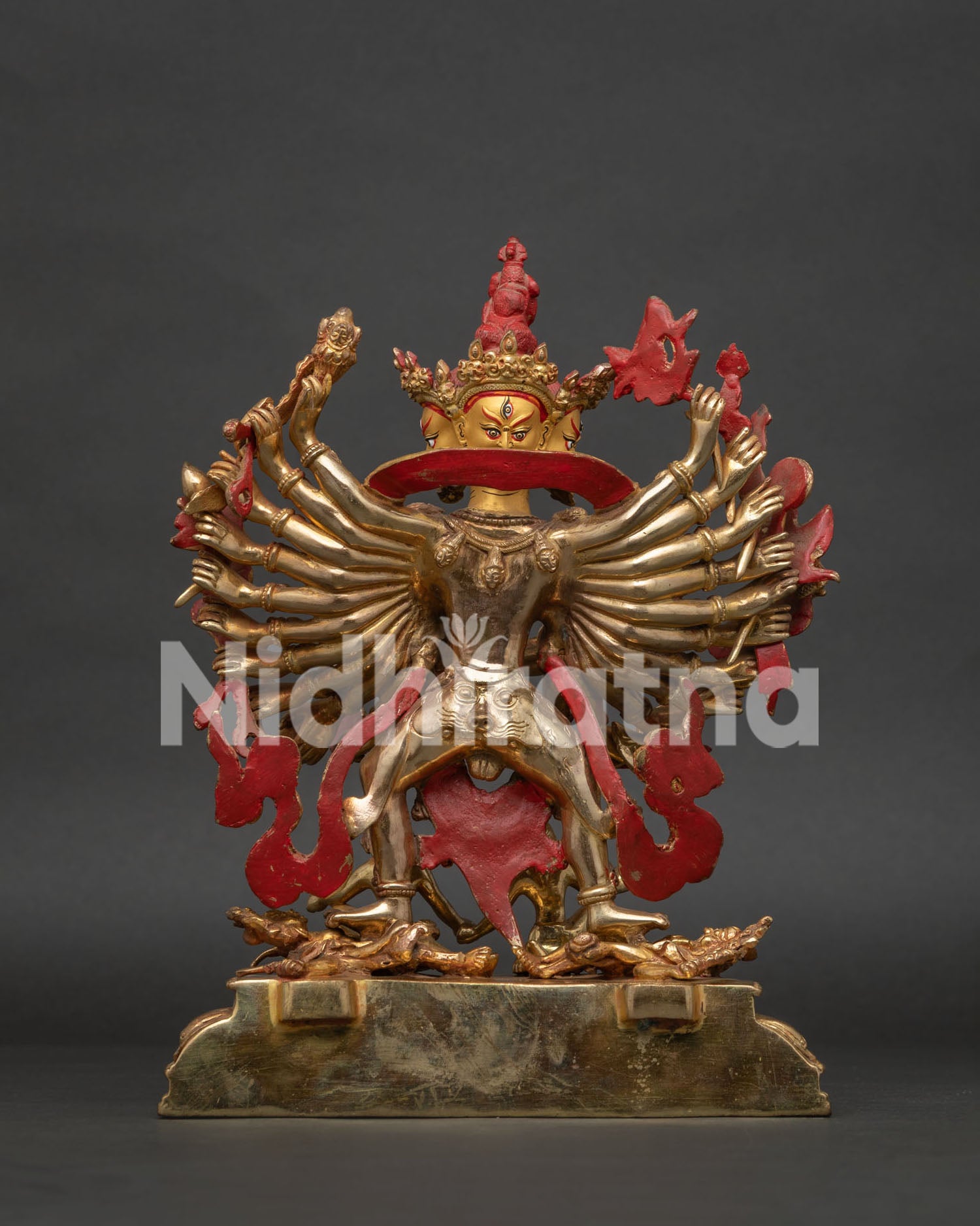 Kalachakra statue subduing two human figures beneath his feet Nepalese Buddhist art
