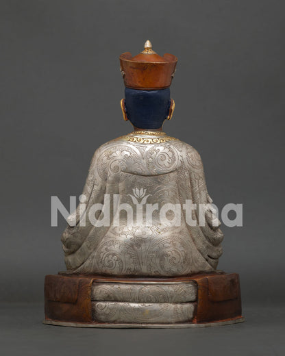Karmapa statue highlighting gold painted face crown and intricate Nepalese details.