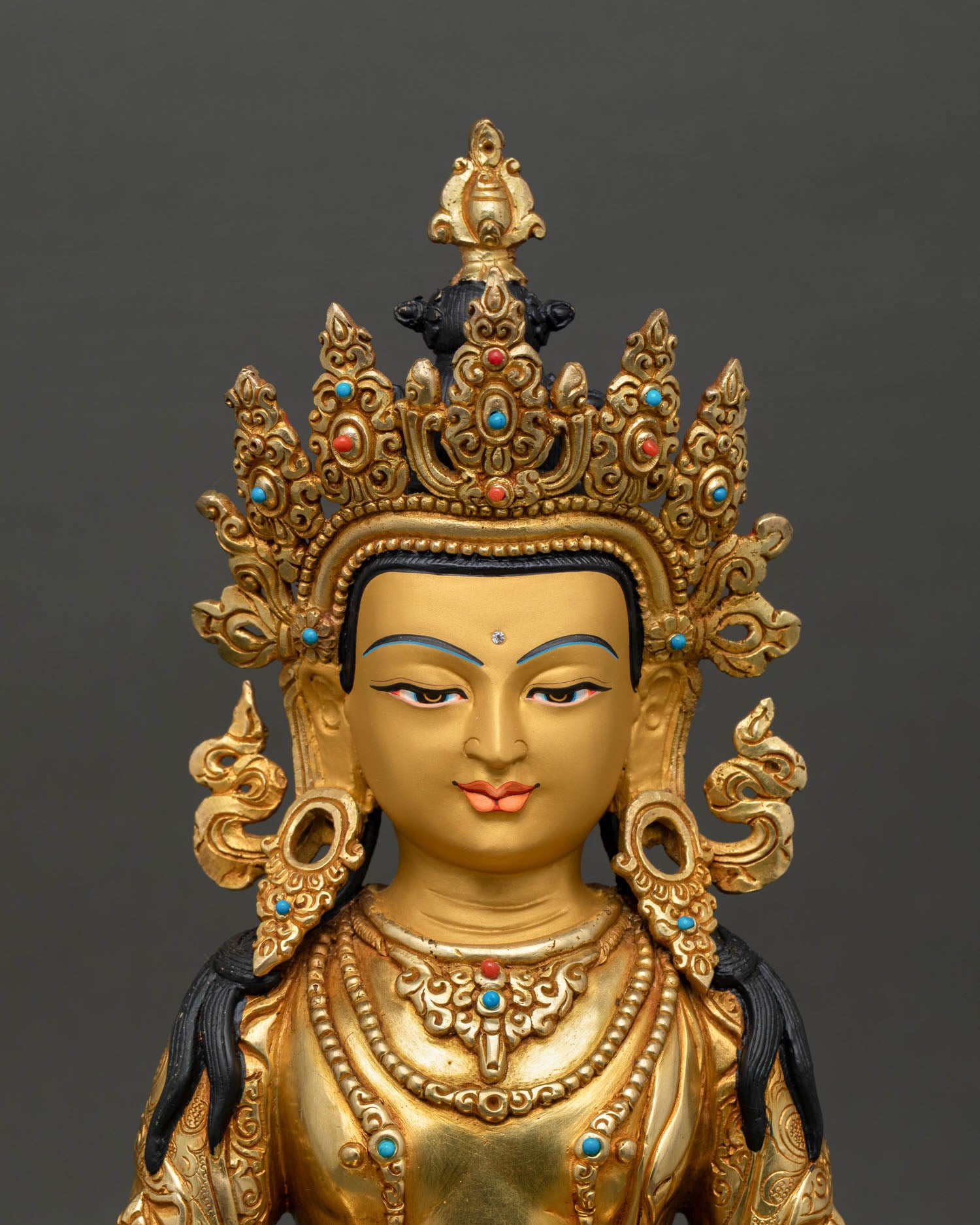Kshitigarbha bodhisattva close up gold painted face turquoise coral stone inlay sacred Himalayan deity spiritual protection art