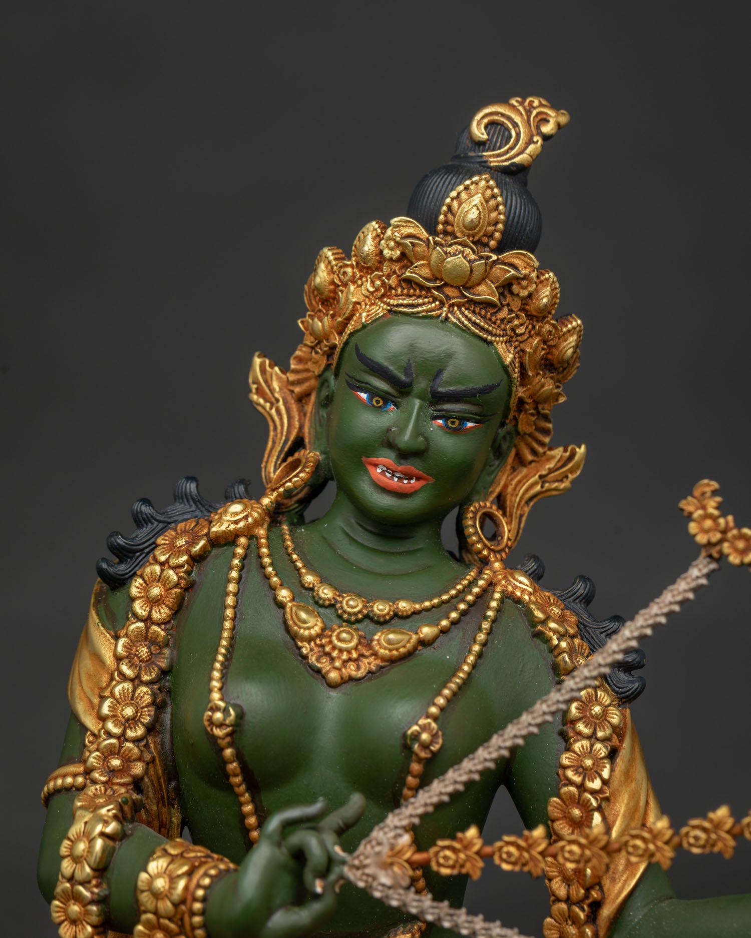 Kurukulla statue close-up – hand-carved gold-gilded copper Buddhist Dakini detail