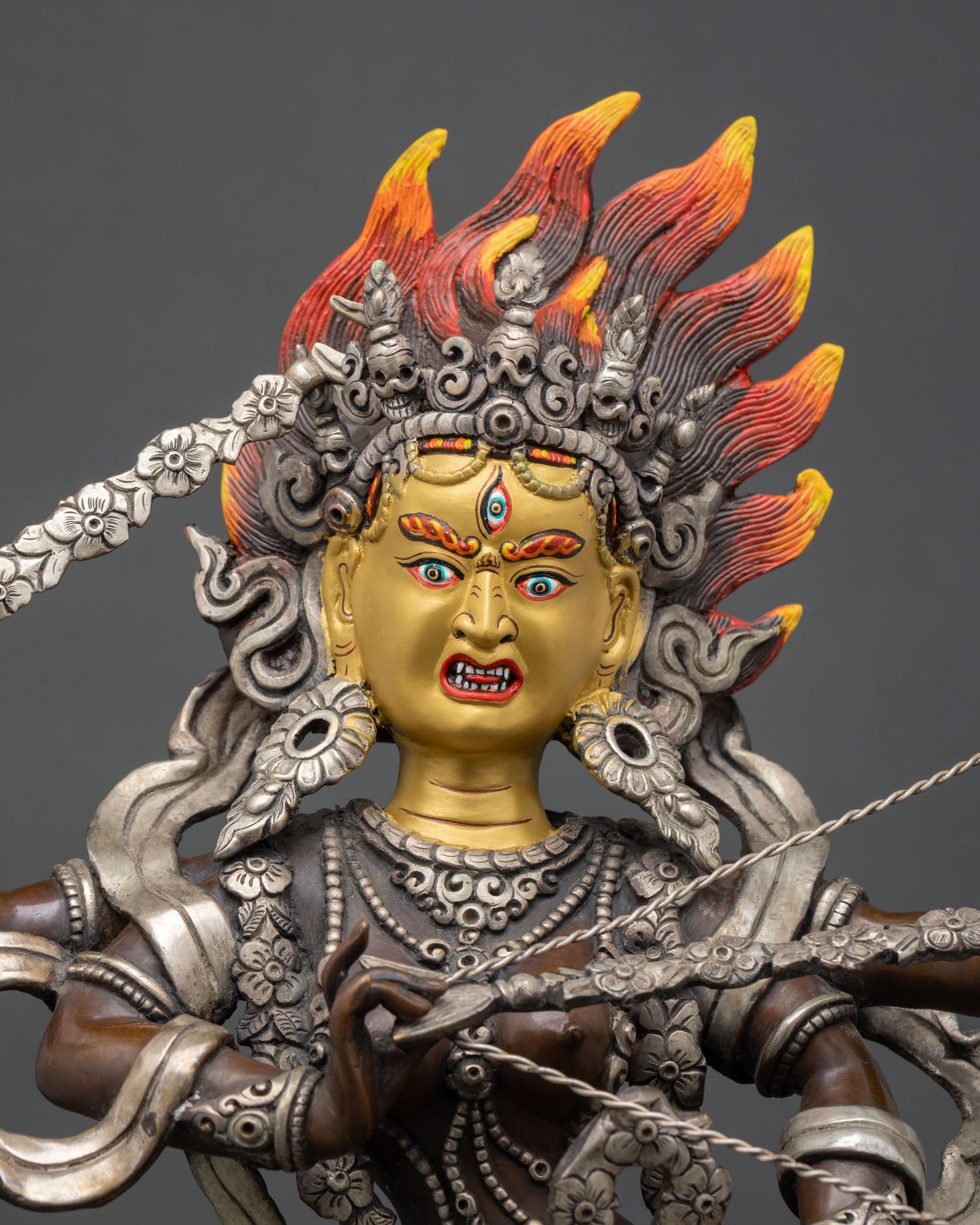 Kurukulla statue close up, oxidized copper detail with gold painted face finish