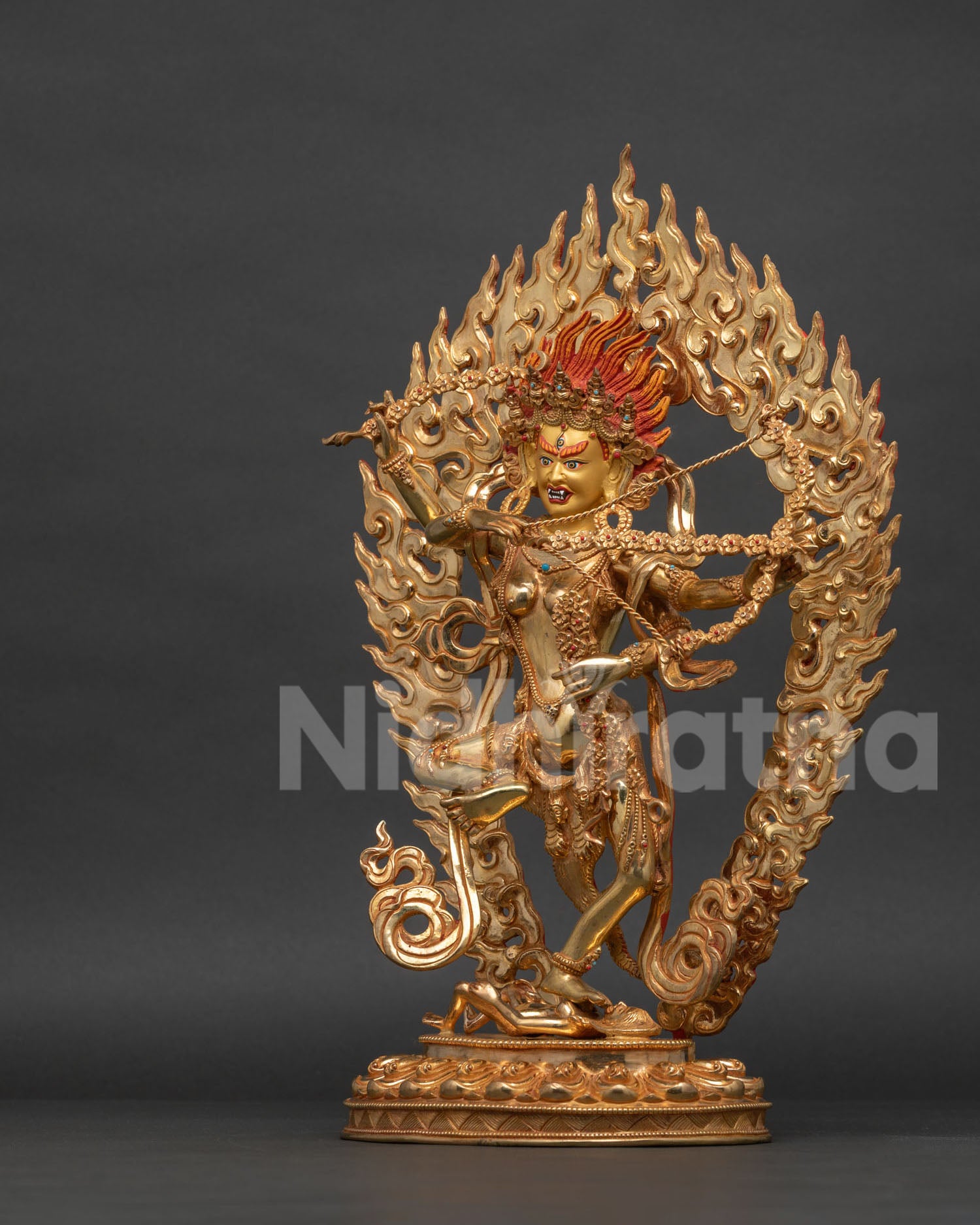 Kurukulla statue dancing above figure tiger skin garment mundamala.