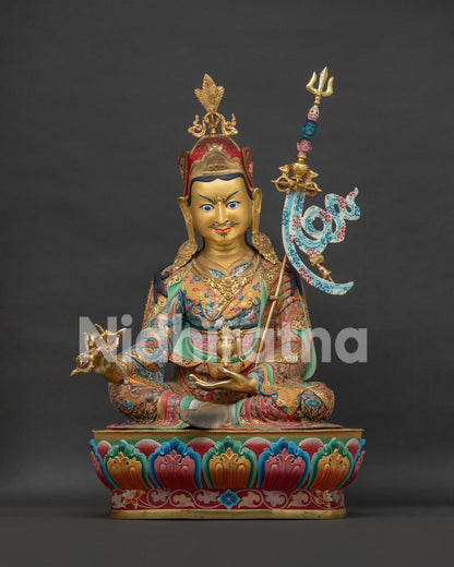 Large Guru Rinpoche Padmasambhava statue front view with radiant gilding and colorful lotus throne