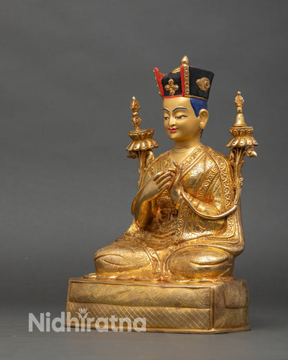 Left profile of 3rd Karmapa Rangjung Dorje statue with flowing monk robe patterns