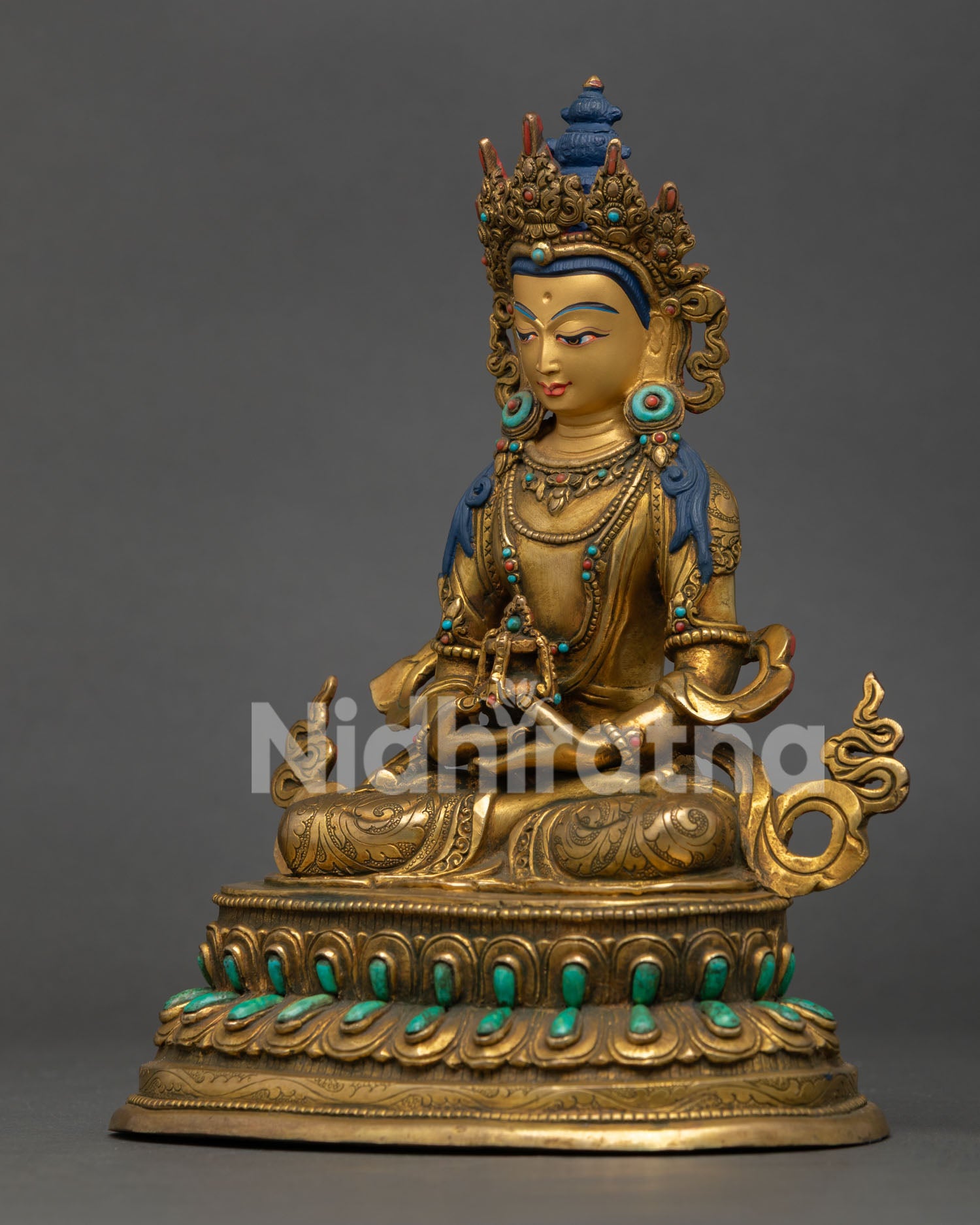 left profile of amitayus statue featuring gold fire gilding turquoise coral and lotus pedestal