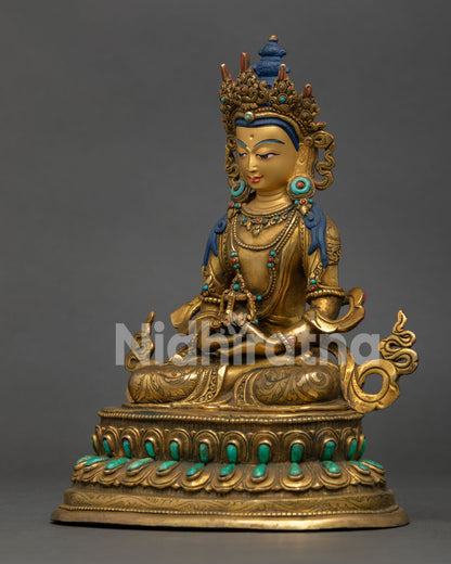left profile of amitayus statue featuring gold fire gilding turquoise coral and lotus pedestal