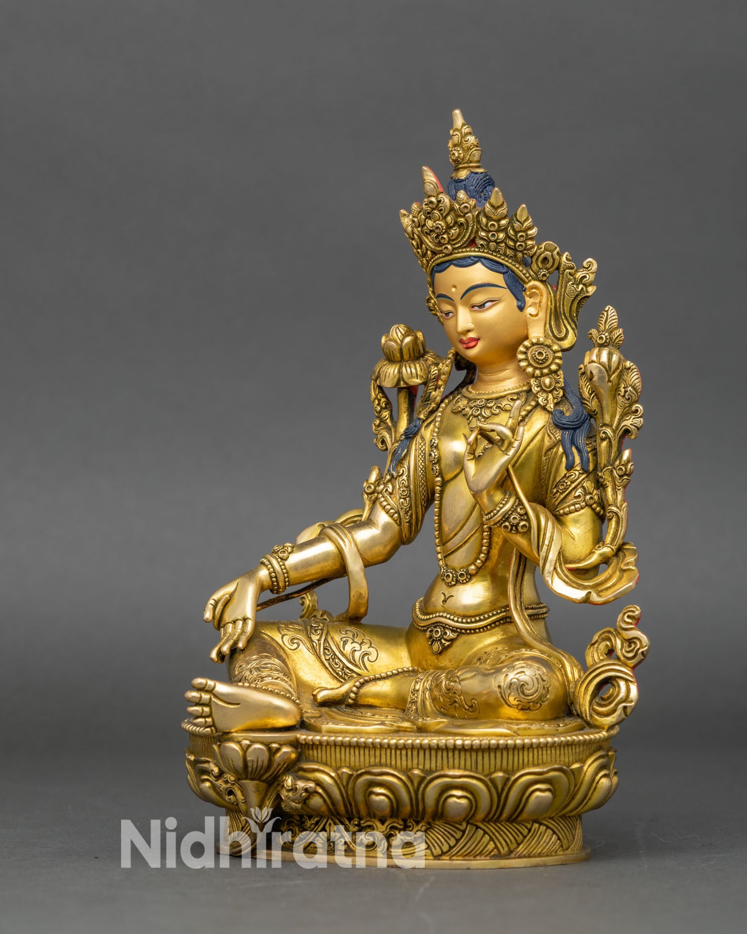 left profile of green tara statue, lotus throne, traditional Nepalese craftsmanship