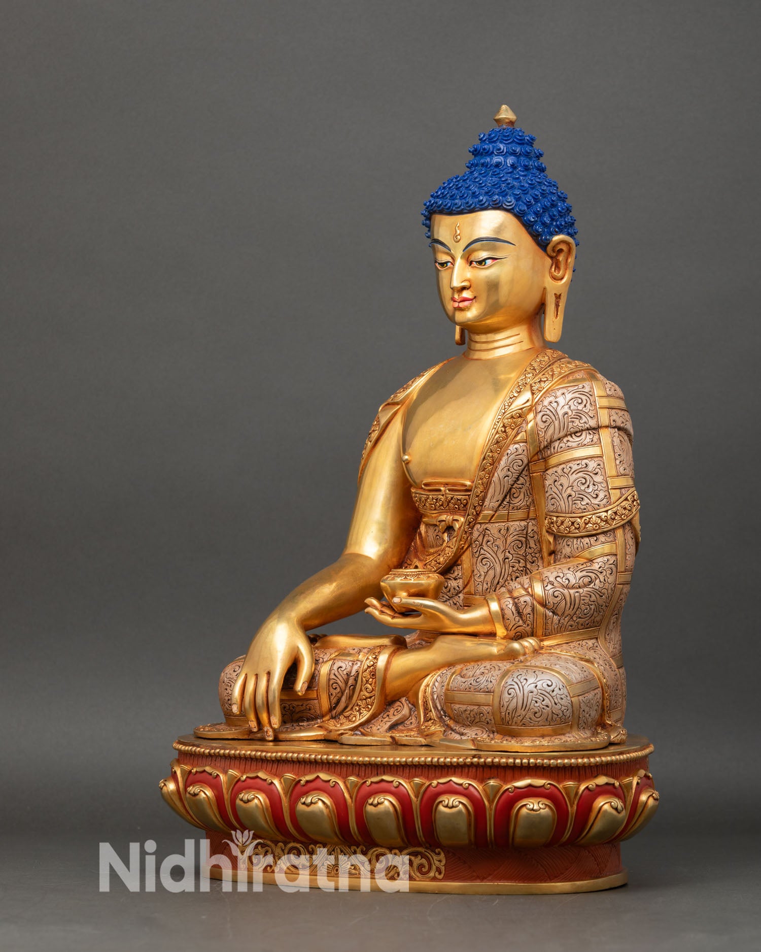 left profile of shakya buddha, meditation pose with gold fire-gilding on copper