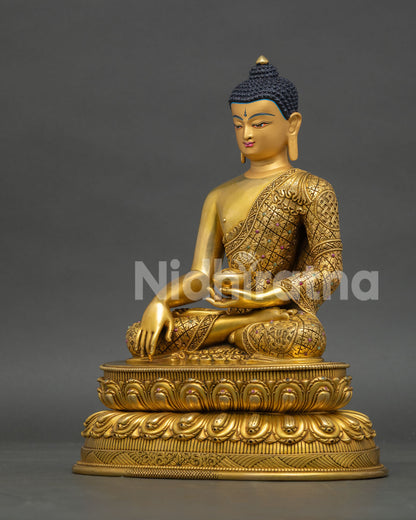 Left profile of Shakyamuni Buddha statue featuring fire-gilded gold finish and Himalayan Buddhist art
